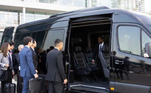 Business group boarding black luxury Sprinter van with leather seating - Executive Van Service Toronto