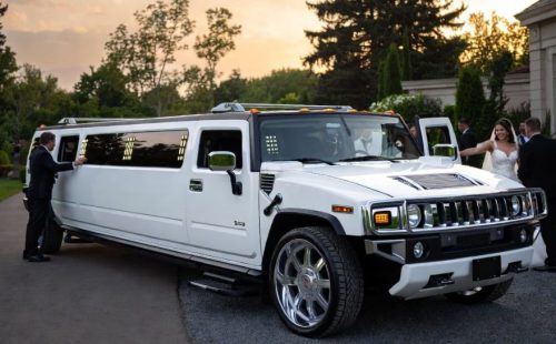 White Hummer H2 stretch limo with chrome accents and LED lighting — seats 18-20, statement wedding entrance, Wedding Limo Toronto.
