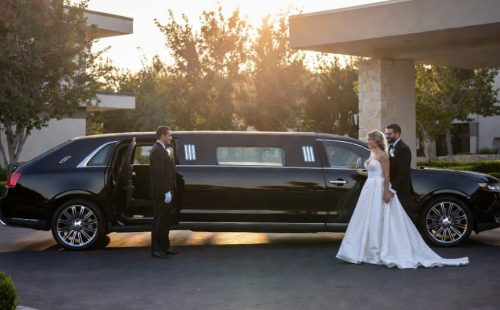 Black Lincoln MKT stretch limo with uniformed chauffeur, chrome wheels and opera lighting — modern wedding limo seats 8-10, Toronto.