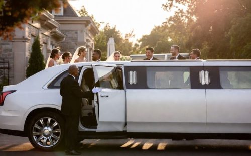 White SUV stretch limo with plush leather seats and ambient lighting — seats 14-18, full bridal party wedding ride, Toronto.
